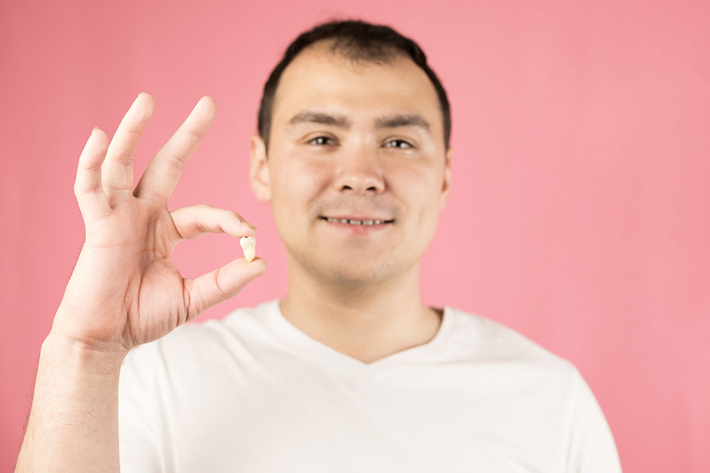 A,Man,In,A,White,T-shirt,On,A,Pink,Background